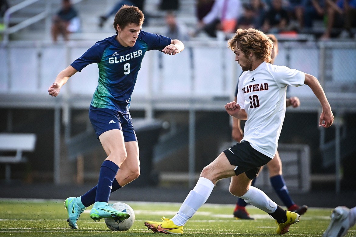 Glacier's Bridger Dalla Betta (9) pushes the ball upfield against Flathead's Landon Saraceno (10) at Legends Stadium on Thursday, Sept. 15. (Casey Kreider/Daily Inter Lake)