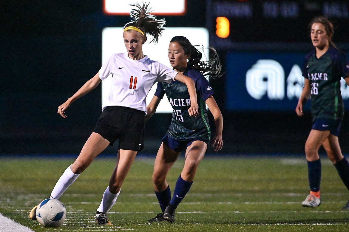 Flathead's Mia Stephan (11) controls the ball against Glacier's Karys Camp (15) at Legends Stadium on Thursday, Sept. 15. (Casey Kreider/Daily Inter Lake)