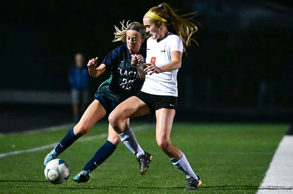 Glacier's Reagan Brisendine (22) battles for possession with Flathead's Maurala Nigon (9) at Legends Stadium on Thursday, Sept. 15. (Casey Kreider/Daily Inter Lake)