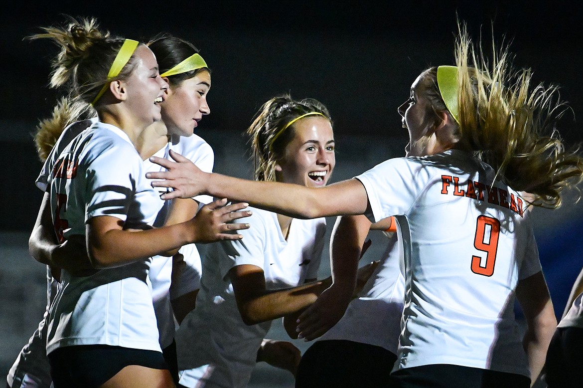 Flathead teammates celebrate with Kyrie Gislason (16, left) after her second goal of the first half against Glacier at Legends Stadium on Thursday, Sept. 15. (Casey Kreider/Daily Inter Lake)