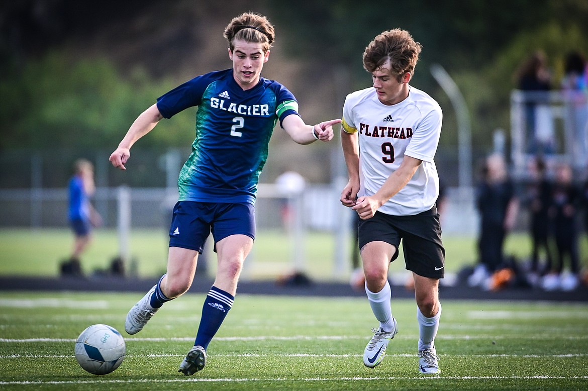 Glacier's Harrison Sanders (2) pushes the ball upfield against Flathead's Richard Hamilton (9) at Legends Stadium on Thursday, Sept. 15. (Casey Kreider/Daily Inter Lake)