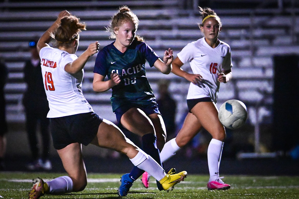 Glacier's Reese Ramey (23) looks to shoot in the first half between Flathead defenders Alivia Rinehart (19) and Kyrie Gislason (16) at Legends Stadium on Thursday, Sept. 15. (Casey Kreider/Daily Inter Lake)