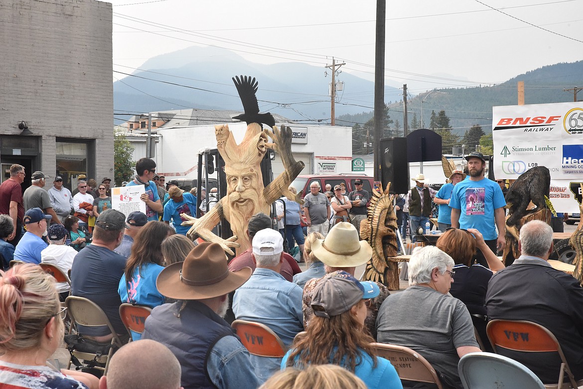 The crowd admires Mark Culp's carving at the Kootenai Country Montana International Chainsaw Carving Championship. (Scott Shindledecker/The Western News)