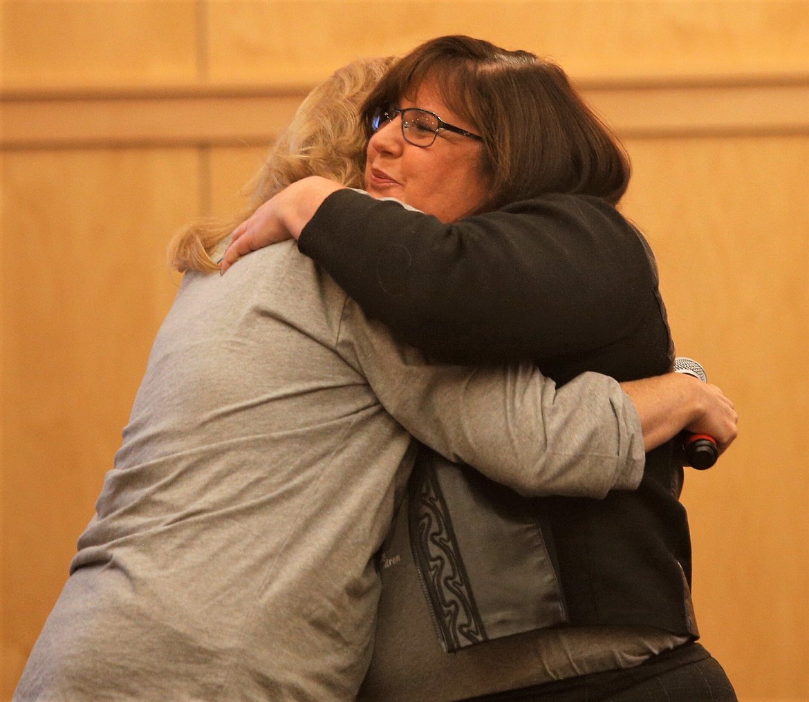 Anjelique Pennington, right, hugs JoAnn Zajicek, UGM center director in Coeur d'Alene, during the organization's 10-year celebration Thursday night.