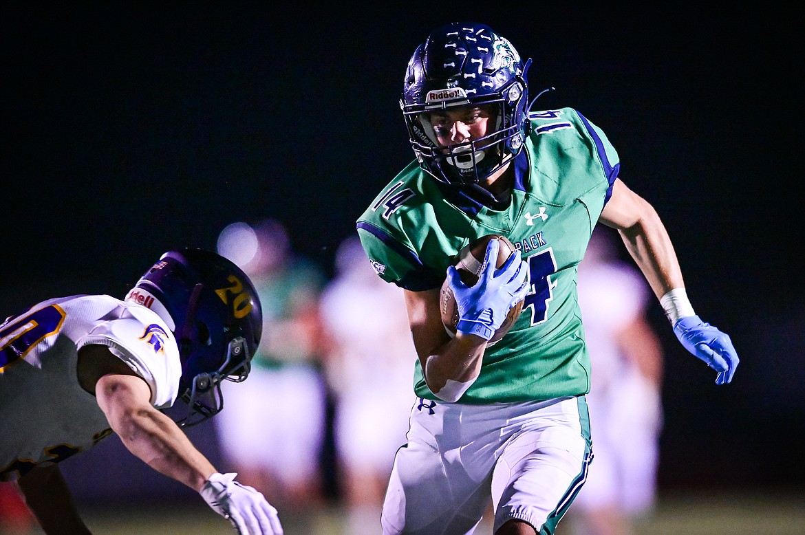 Glacier wide receiver Kaid Buls (14) picks up a first down on a fourth down reception in the fourth quarter against Missoula Sentinel at Legends Stadium on Friday, Sept. 16. (Casey Kreider/Daily Inter Lake)