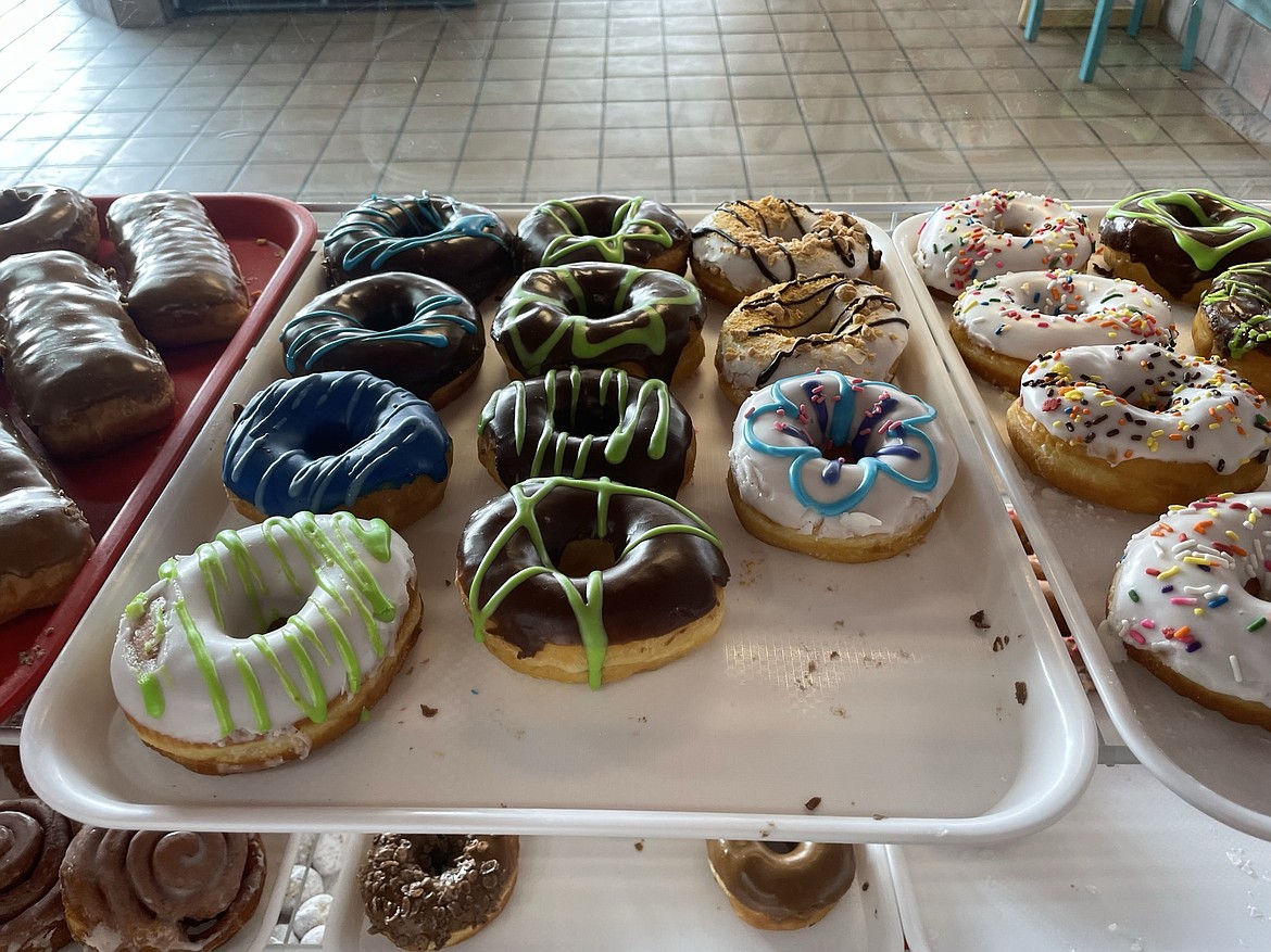 Glazed donuts sit waiting to be bought and eaten in the Corner St. Donuts display case.