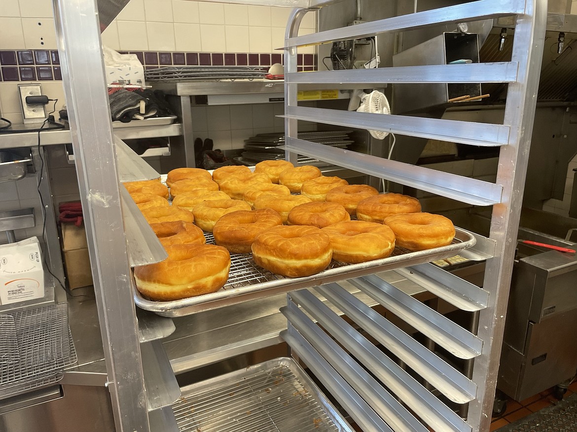 Freshly fried donuts await icing in the kitchen of Corner St. Donuts.