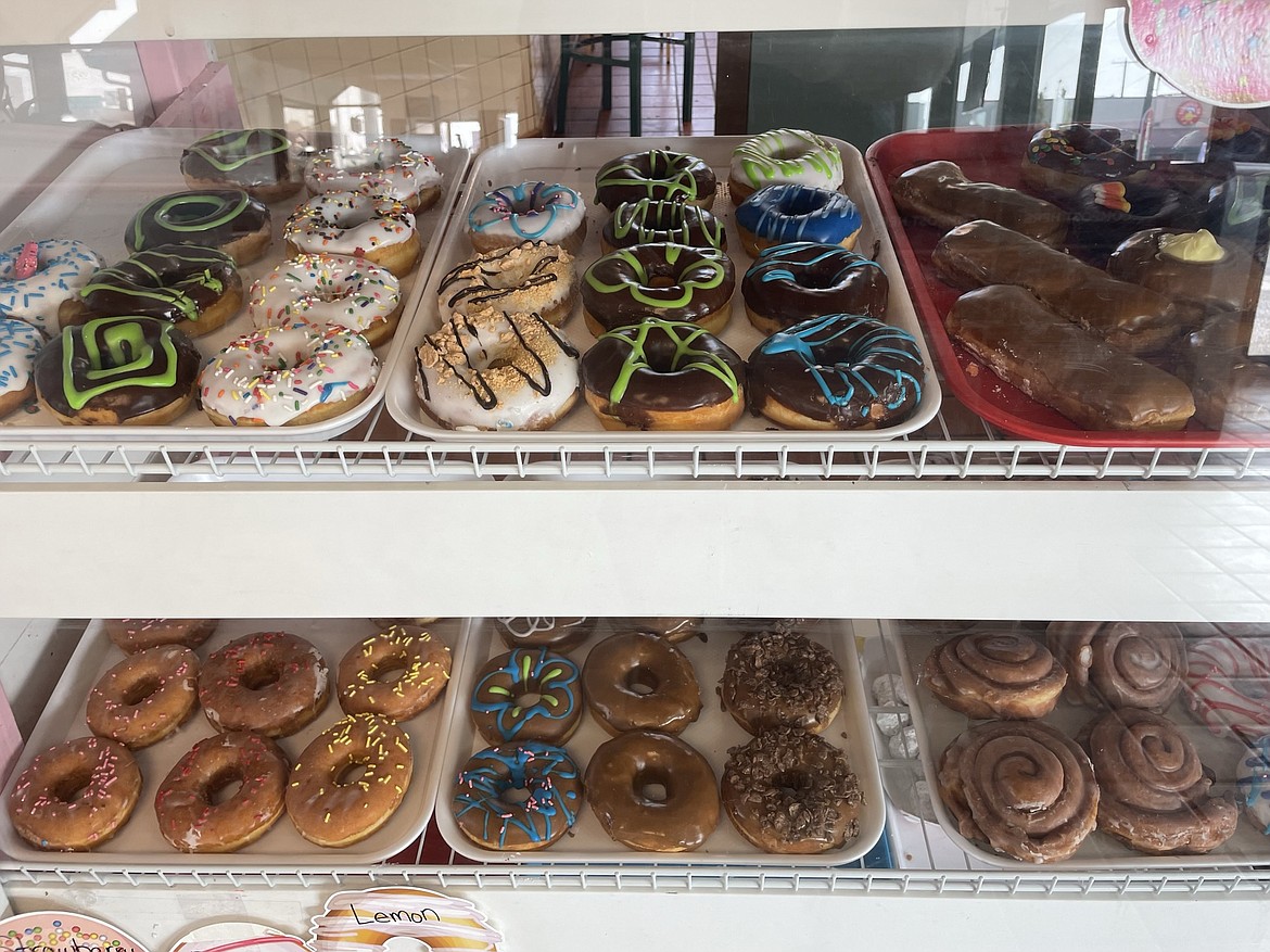 Glazed donuts sit waiting to be bought and eaten in the Corner St. Donuts display case.