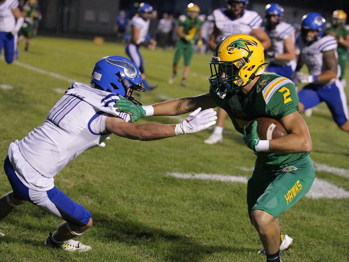 JASON ELLIOTT/Press
Lakeland sophomore wide receiver Ezra Benson fights off the tackle of Coeur d'Alene senior defensive back John Haynes during the first quarter of Friday's game in Rathdrum.