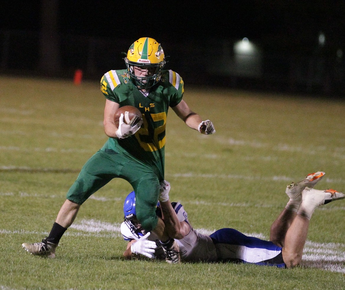 JASON ELLIOTT/Press
Lakeland senior running back John Cornish tries to extend his run through the grasp of Coeur d'Alene senior linebacker Brandon Whitby during the third quarter of Friday's game in Rathdrum.