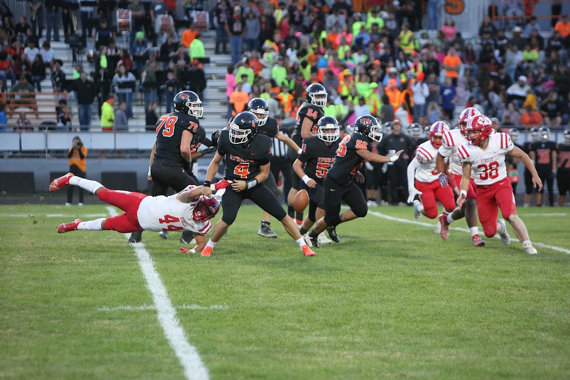 Othello’s David Julian Alegria forces a fumble of Ephrata quarterback Travis Hendrick in the first quarter of Friday’s game.