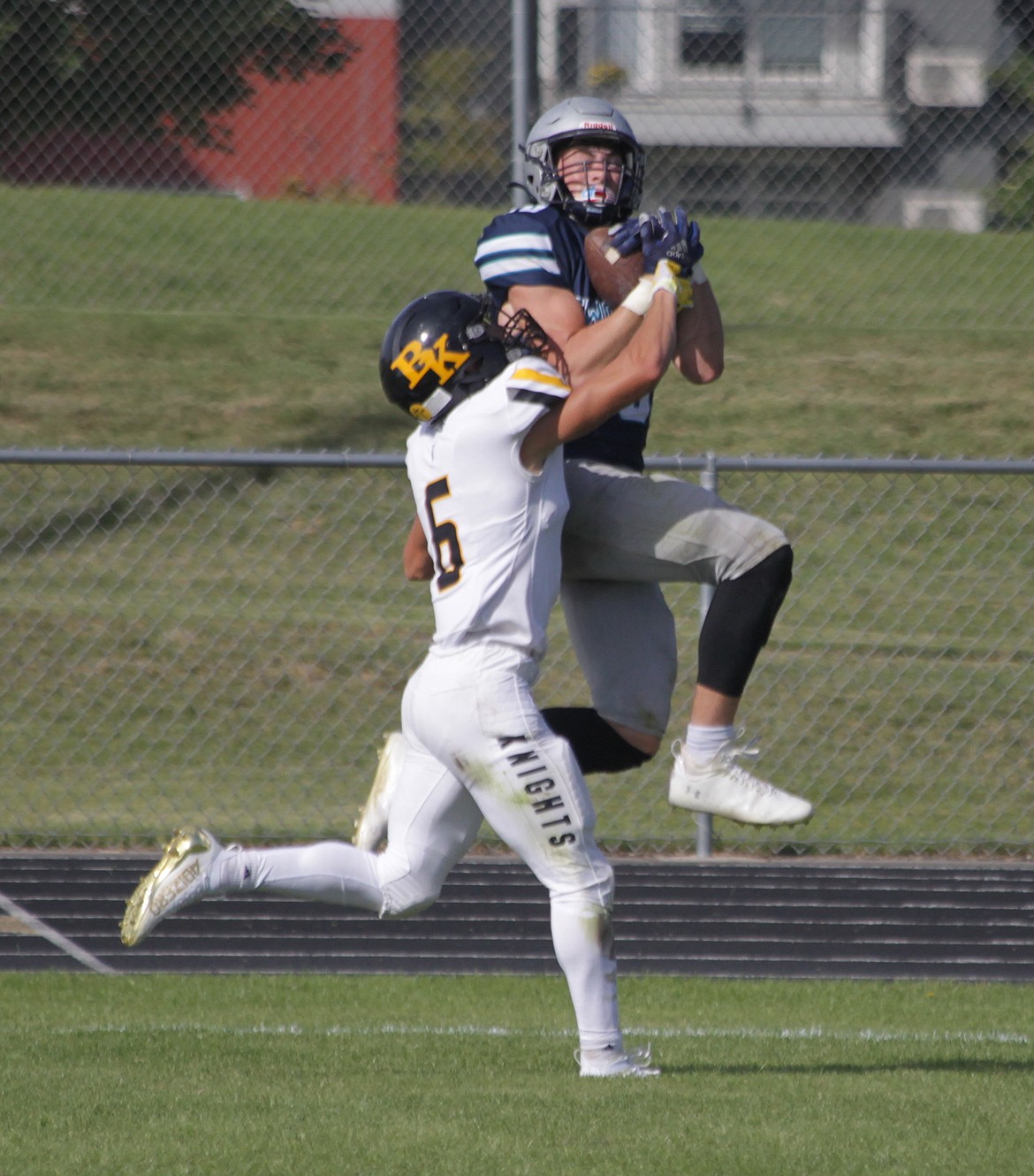 MARK NELKE/Press
Zach Johnson of Lake City catches a touchdown pass in the fourth quarter as Sam Knell of Bishop Kelly defends on Saturday at Lake City.