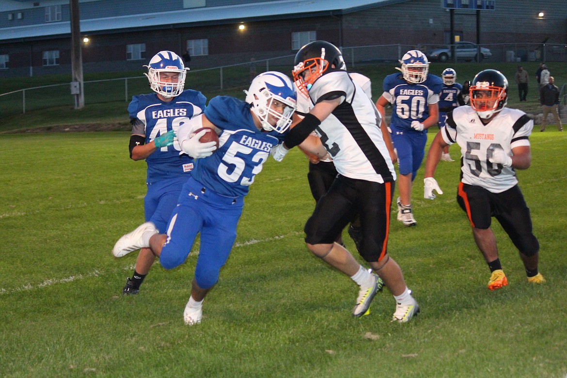 Soap Lake running back Anthony Contreras (53) fights off a Bridgeport defender.