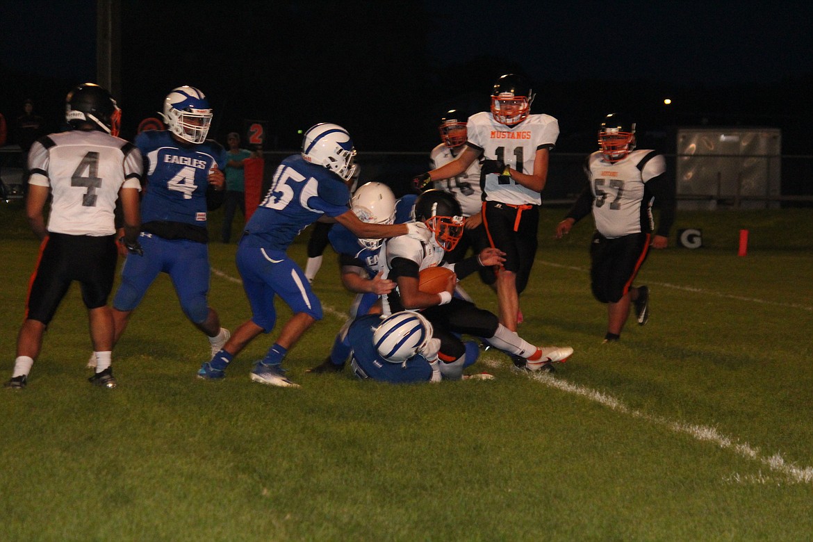 The Soap Lake defense stacks up a Bridgeport running back during the Eagles’ 22-0 loss to the Mustangs.