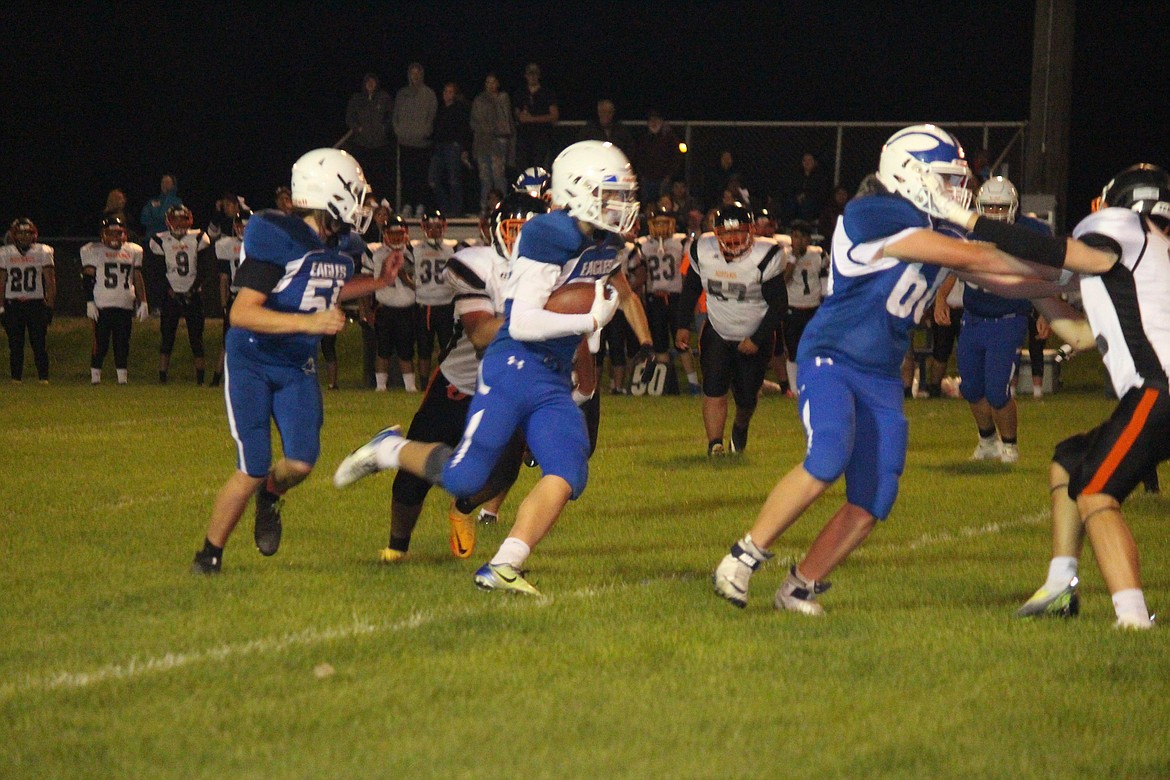 Accompanied by his blockers, Soap Lake’s Sam Schopf (with football) heads downfield during the Eagles’ 22-0 loss to Bridgeport Friday.