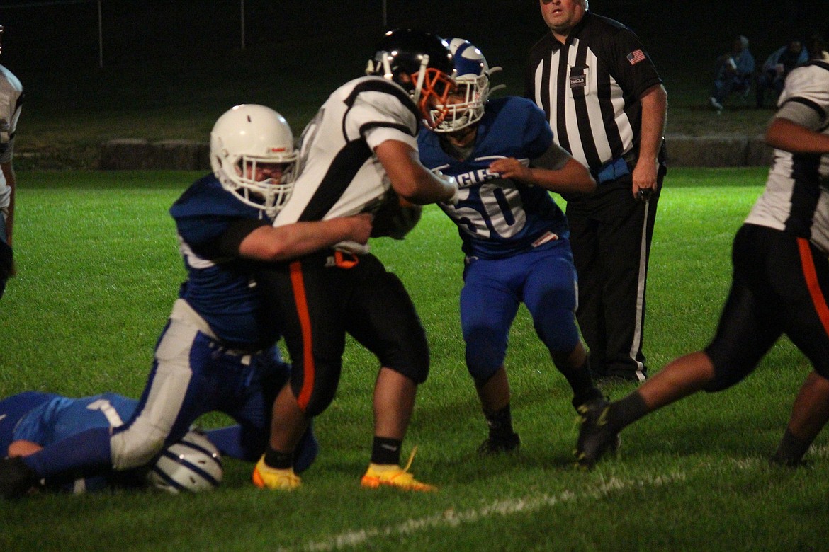 The Soap Lake defense wraps up a Bridgeport runner in the Eagles’ 22-0 loss to the Mustangs Friday.