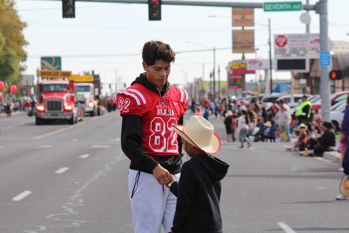 Xzyan Martinez stops to talk with a spectator during the Othello Fair parade Saturday.