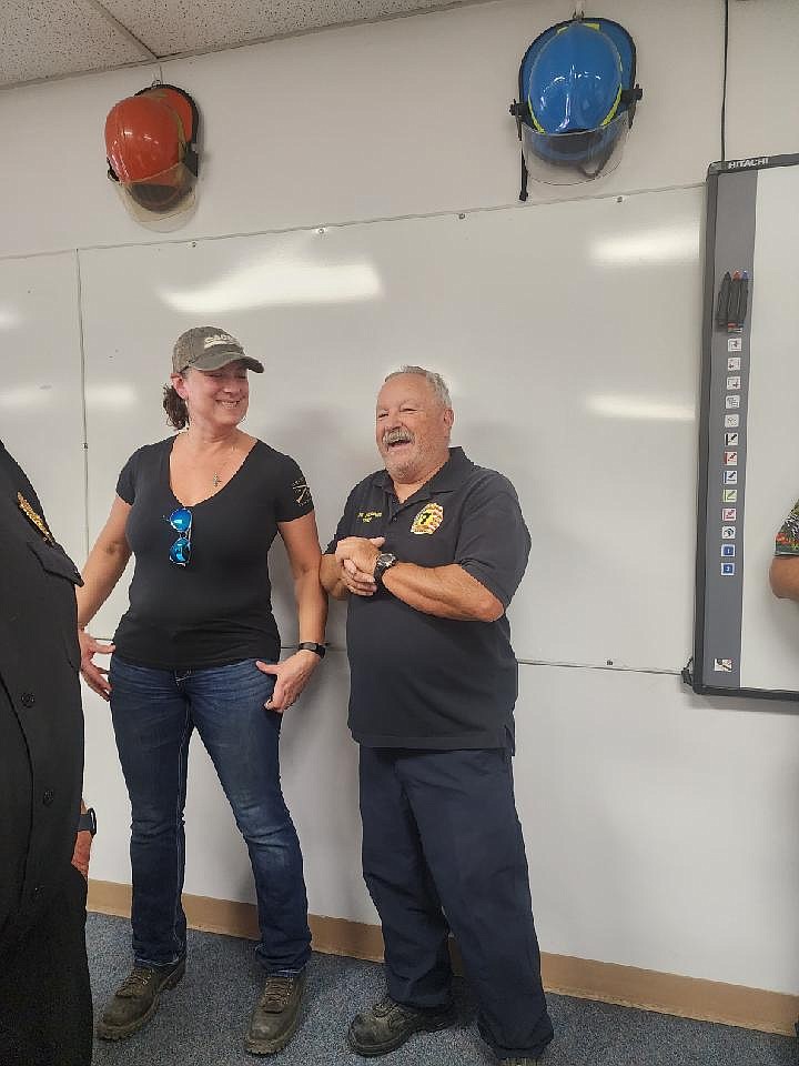 Kirk Sheppard, right, smiles as he stands next to Christy O'Keefe at the open house for his and his wife’s retirement from Grant County Fire District 7.