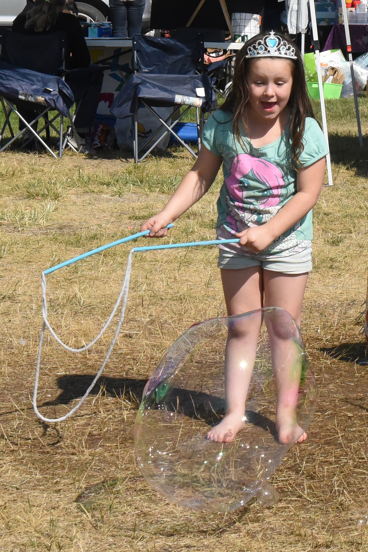 This little princess is thrilled with the big bubble she has created. This was one of the most popular events for kids at Harvest Fest in Ronan. (Marla Hall/Lake County Leader)