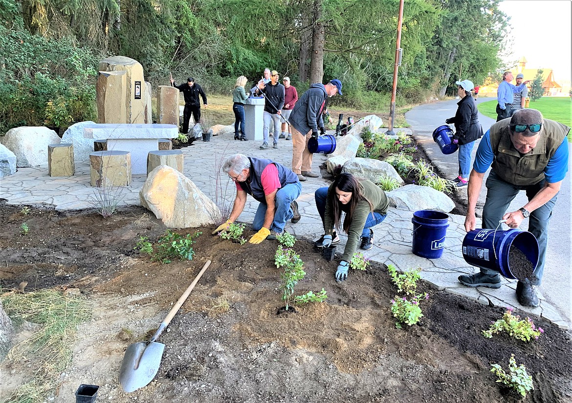 Members of the Sunrise Rotary Club of Coeur d'Alene plant flowers and native species at the Dwight Bershaw memorial area at McEuen Park on Tuesday morning. Bershaw, a longtime Coeur d'Alene resident, volunteer and Rotary member, died Aug. 20, 2021, at the age of 54. The Sunrise Rotary Club organized the memorial project in his honor. A dedication at the memorial is scheduled for 1 p.m. Oct. 15, and the public is welcome.