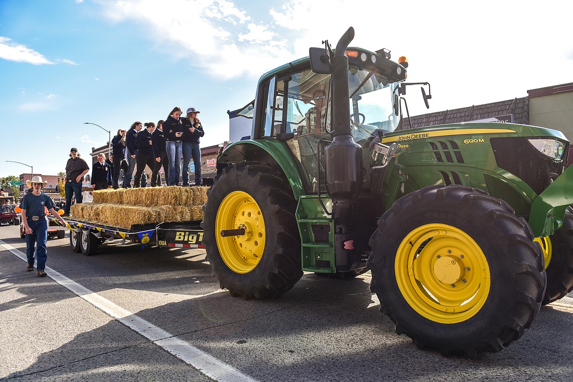 Members of the Future Farmers of America club are pulled behind a tractor during the Flathead High School Homecoming Parade along Main Street on Wednesday, Sept. 21. (Casey Kreider/Daily Inter Lake)