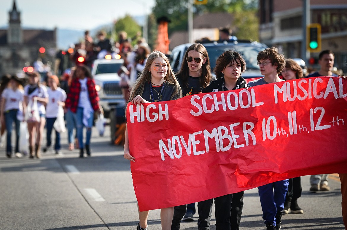 Members of the theater program walk in the procession during the Flathead High School Homecoming Parade along Main Street on Wednesday, Sept. 21. (Casey Kreider/Daily Inter Lake)