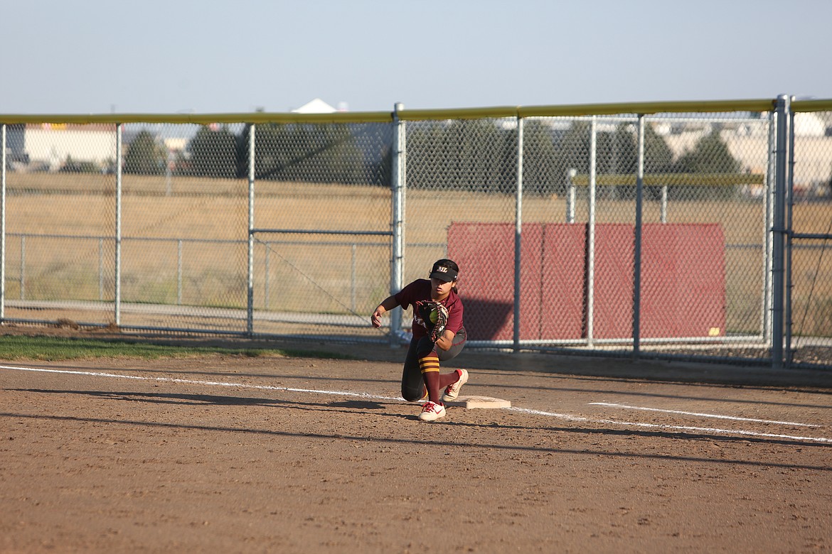 Sitting on first base, freshman Alina Lopez catches a pass from a teammate for an out. Head coach Mike Hofhenis said that freshmen get a lot out of the slow pitch season in preparation for the fastpitch season.