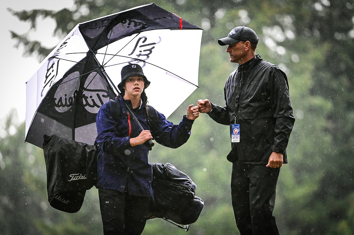 Glacier's Chloe Tanner bumps fists with coach Chris Michno after the third hole during Western AA Divisionals at Buffalo Hill Golf Club on Thursday, Sept. 22. (Casey Kreider/Daily Inter Lake)