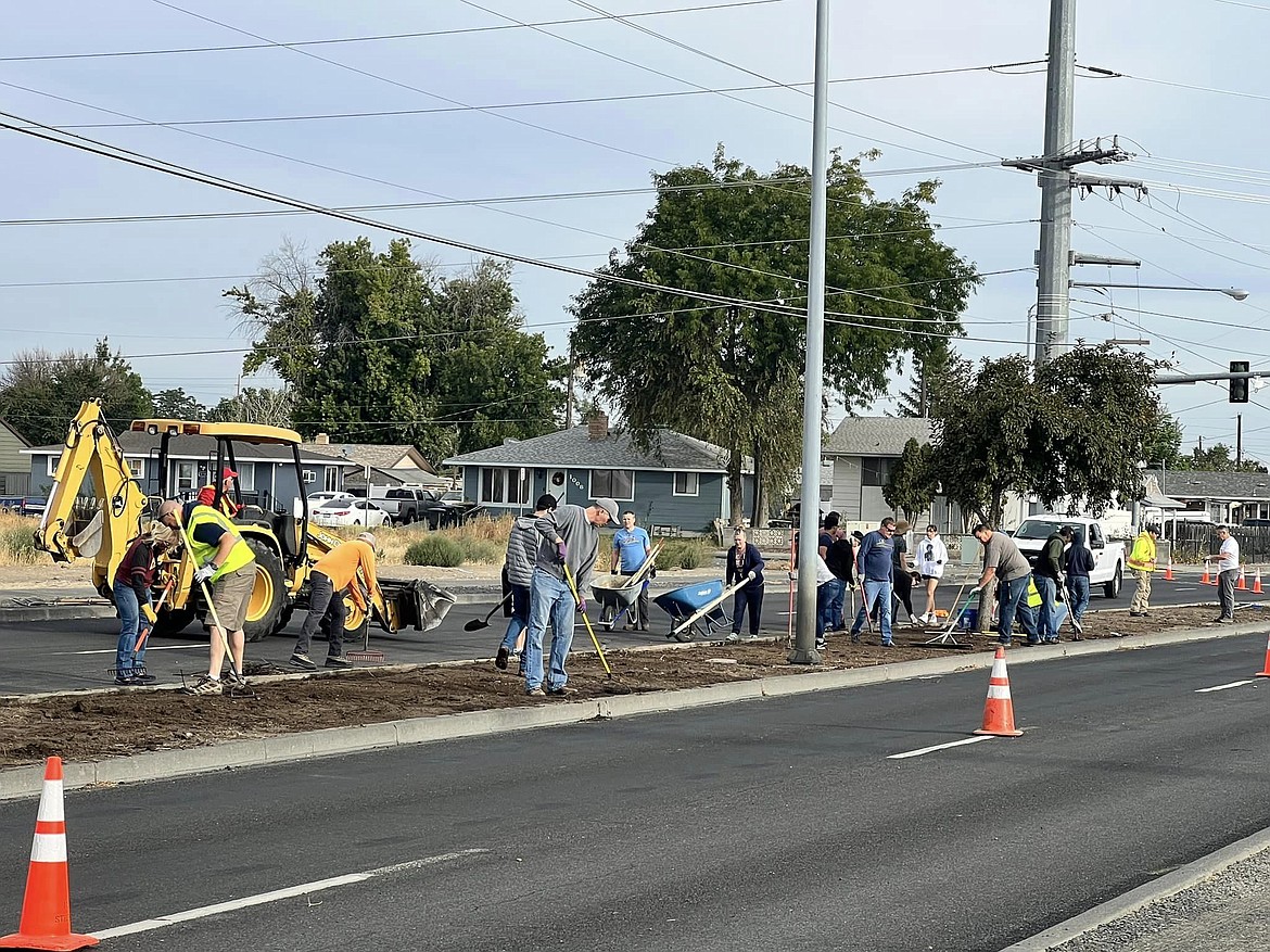 Members of the Church of Jesus Christ of Latter-day Saints, Moses Lake Alliance Church and Patriot Church work the soil in the median strip of Grape Drive just south of Central Drive on a recent Saturday as part of a joint service project to replace the vegetation and beautify the street.