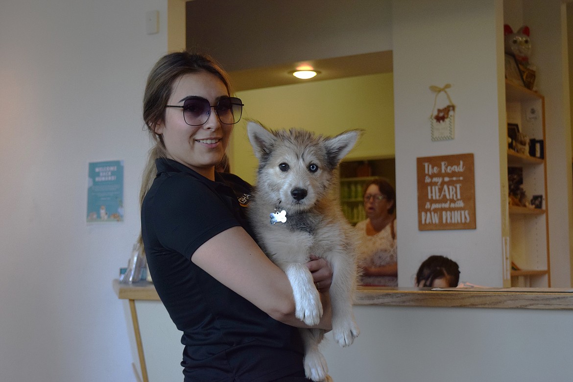 Jacky Herrera holds her puppy Mila in the reception area of Pioneer Veterinary Clinic.