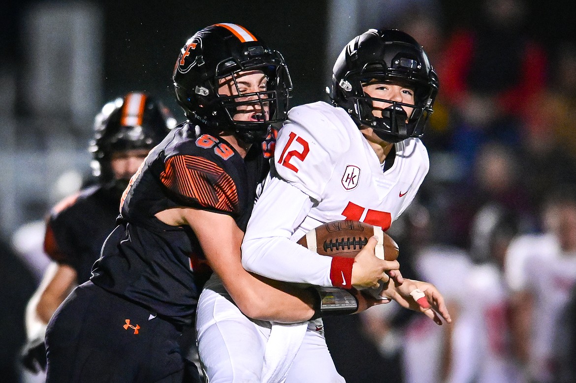 Flathead defensive lineman Sawyer Troupe (69) sacks Missoula Hellgate quarterback Rylan Davis (12) in the second quarter at Legends Stadium on Friday, Sept. 23. (Casey Kreider/Daily Inter Lake)