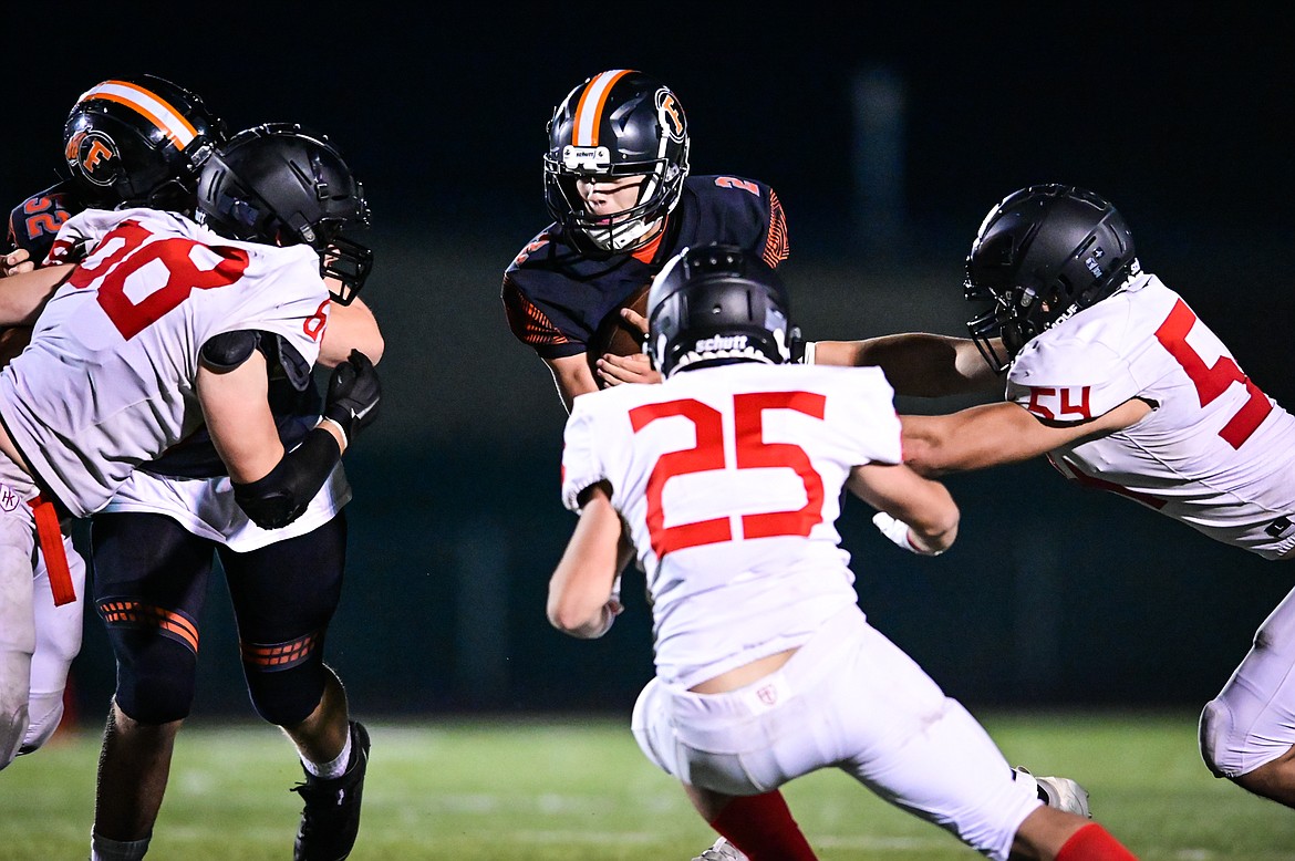 Flathead quarterback Jackson Walker (2)  picks up yardage on a run in the third quarter against Missoula Hellgate at Legends Stadium on Friday, Sept. 23. (Casey Kreider/Daily Inter Lake)