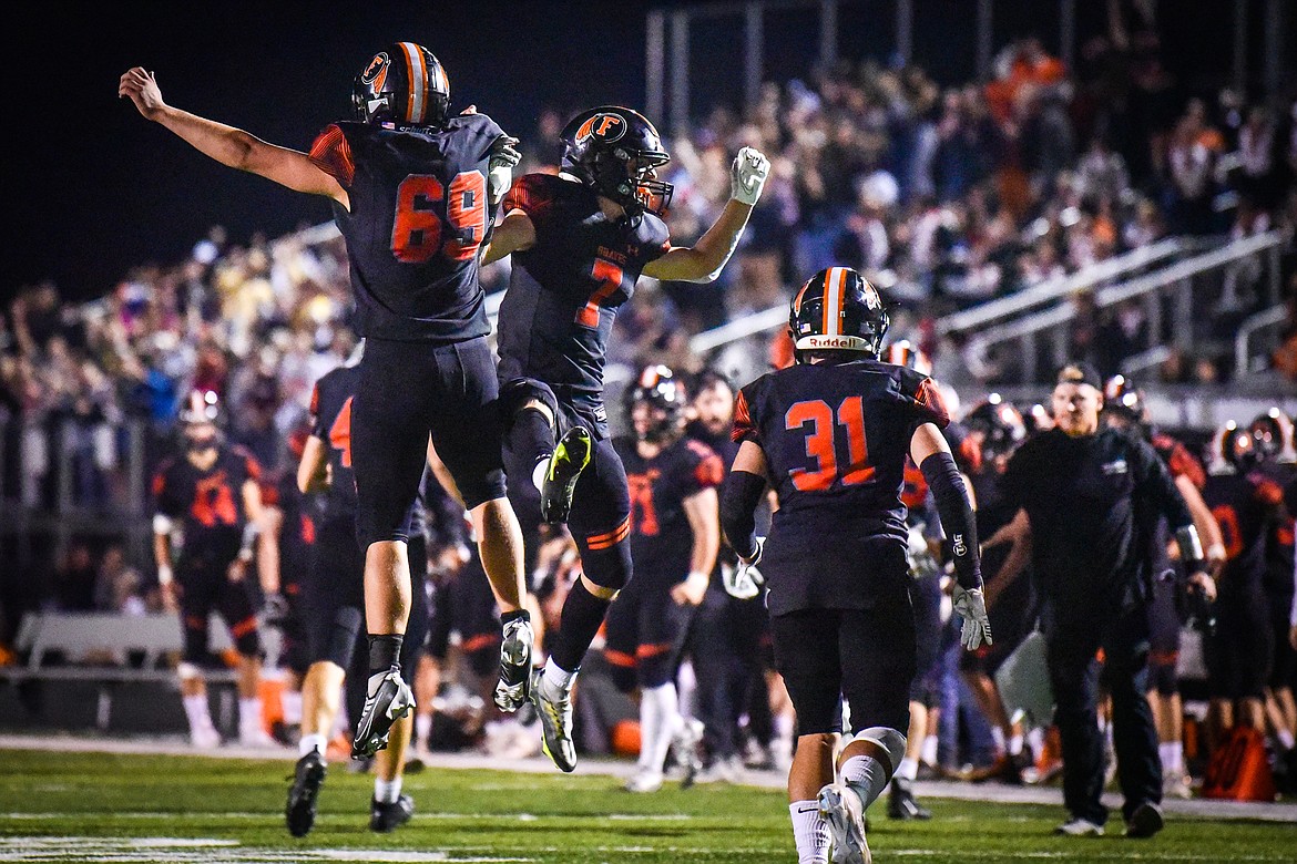 Flathead defenders Sawyer Troupe (69) and Stephen Riley (7) celebrate after Troupe tackled Missoula Hellgate running back Alden Hellem in the end zone for a safety in the third quarter at Legends Stadium on Friday, Sept. 23. (Casey Kreider/Daily Inter Lake)