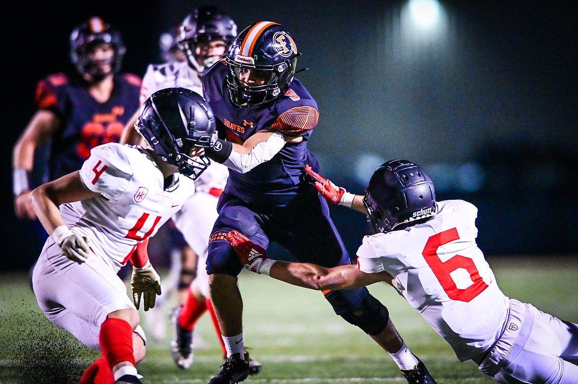 Flathead running back Joe Jones (9) picks up yardage on a run in the third quarter against Missoula Hellgate at Legends Stadium on Friday, Sept. 23. (Casey Kreider/Daily Inter Lake)