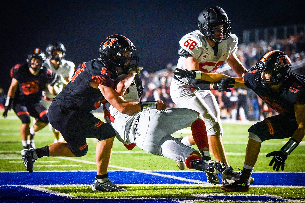 Flathead defensive lineman Sawyer Troupe (69) tackles Missoula Hellgate running back Alden Hellem in the end zone for a safety in the third quarter at Legends Stadium on Friday, Sept. 23. (Casey Kreider/Daily Inter Lake)