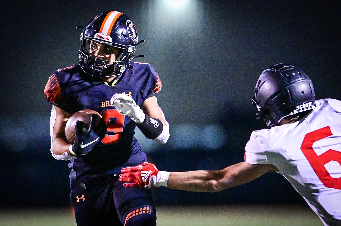 Flathead running back Joe Jones (9) picks up yardage on a run in the third quarter against Missoula Hellgate at Legends Stadium on Friday, Sept. 23. (Casey Kreider/Daily Inter Lake)