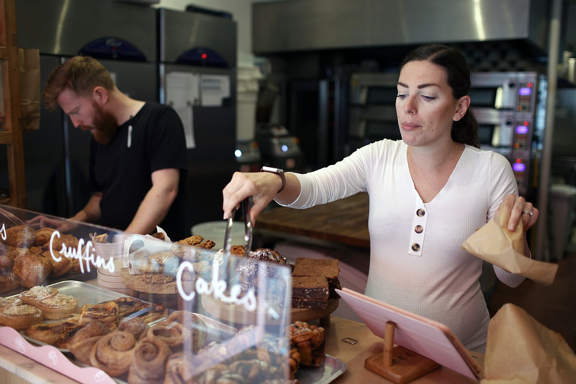 Sophia Sutton-Jones works in her bakery Sourdough Sophia in London, Wednesday, Sept. 21, 2022. At the store, in the Crouch End neighbourhood of north London, the electricity bill has more than tripled since the start of the year, to roughly 5,500 pounds ($6,260) a month, up from 1,500 in January – a crushing increase that's making life difficult for the independent business. The bakery's woes underscore how energy price spikes are threatening companies, alongside a cost of living crisis afflicting Britain and much of Europe. (AP Photo/David Cliff)