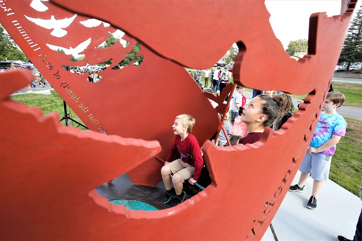 Students gather inside and around "The Monument to Peace and Unity" following Friday's dedication of the artwork in Coeur d'Alene.