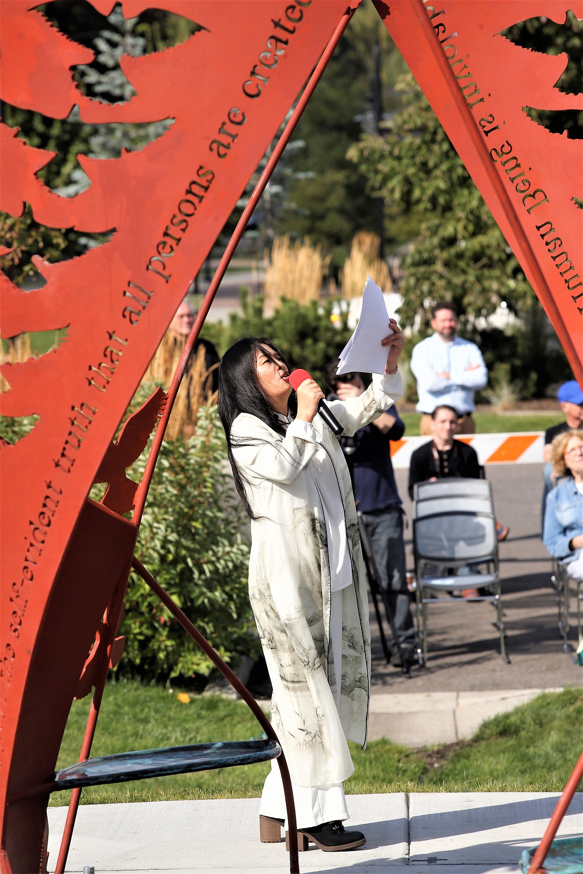 Ai Qiu Hopen addresses the crowd during the dedication of her artwork, "The Monument to Peace and Unity," on Friday in Coeur d'Alene.