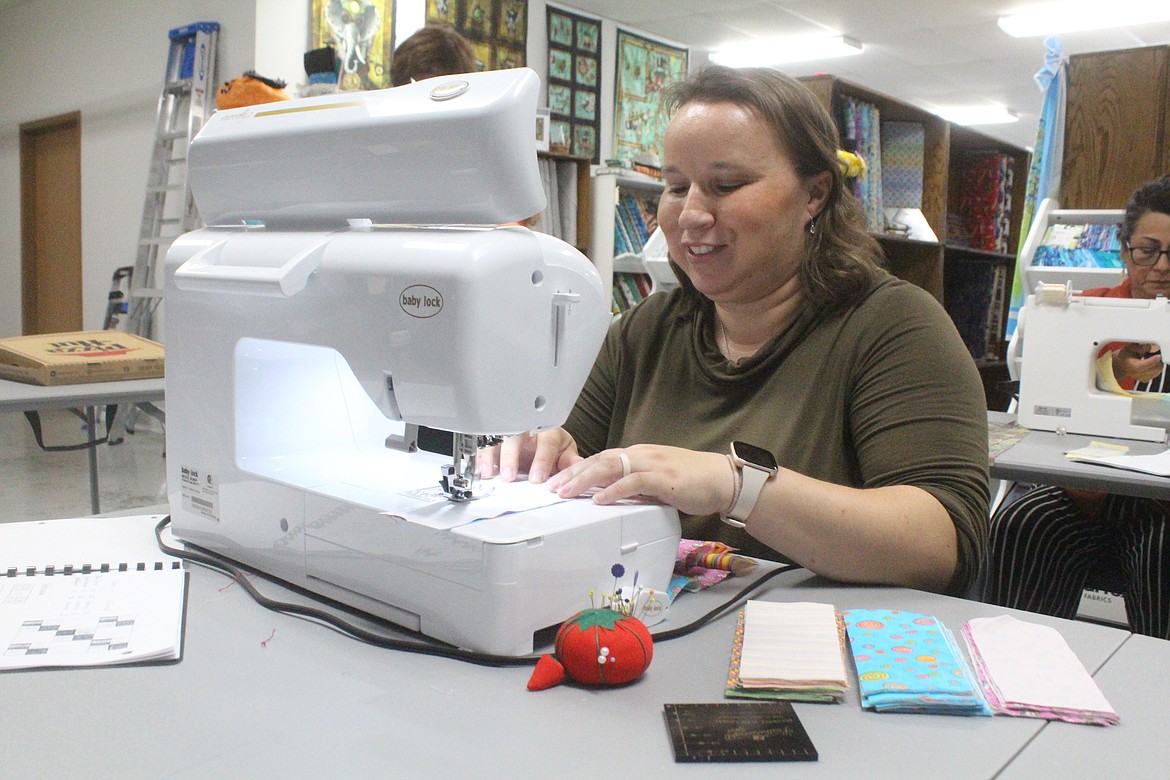 Stitch N Time owner Sophie Mattson works on a project during a class at her shop in Moses Lake.