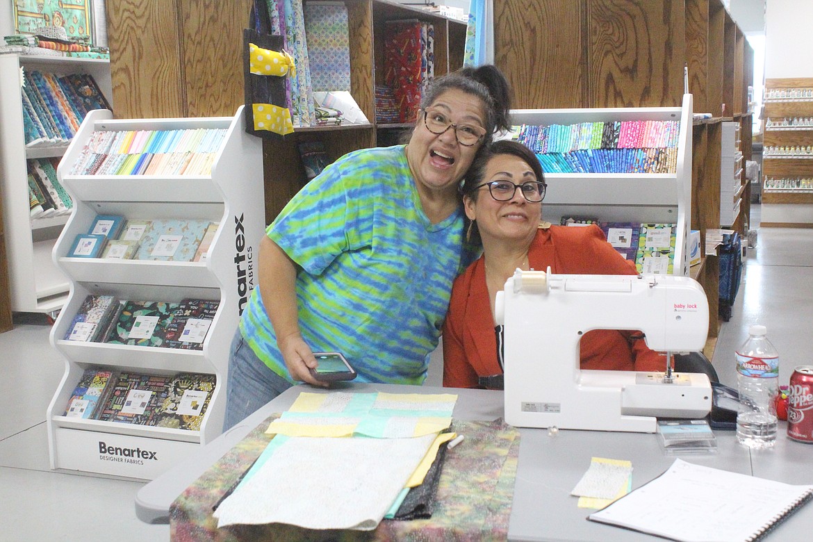 Beginning quilter Rita Reyna (left) and Stitch N Time employee Alma Saucedo (right) during a class at the shop Thursday.