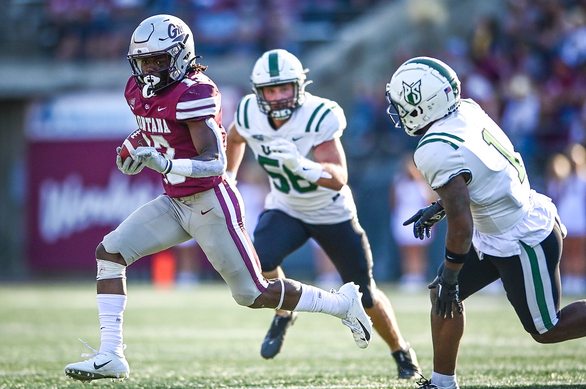 Grizzlies running back Xavier Harris (13) picks up yardage on a run in the fourth quarter against Portland State at Washington-Grizzly Stadium on Saturday, Sept. 24. (Casey Kreider/Daily Inter Lake)