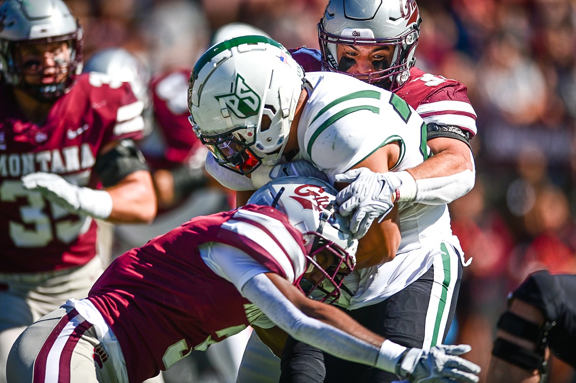 Montana defenders Trajon Cotton (3) and Marcus Welnel (37) stop Portland State running back JoJo Siofele (25) on a run in the first quarter at Washington-Grizzly Stadium on Saturday, Sept. 24. (Casey Kreider/Daily Inter Lake)
