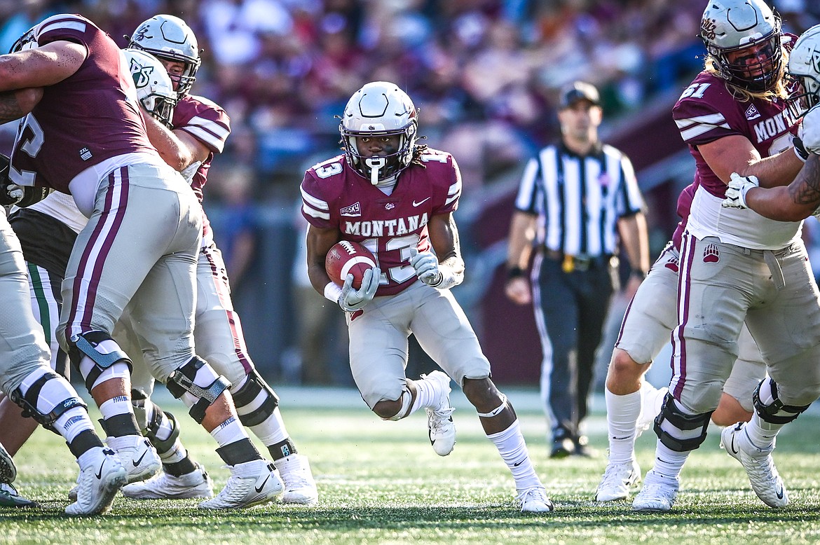 Montana running back Xavier Harris (13) runs through a hole in the fourth quarter against Portland State at Washington-Grizzly Stadium on Saturday, Sept. 24. (Casey Kreider/Daily Inter Lake)
