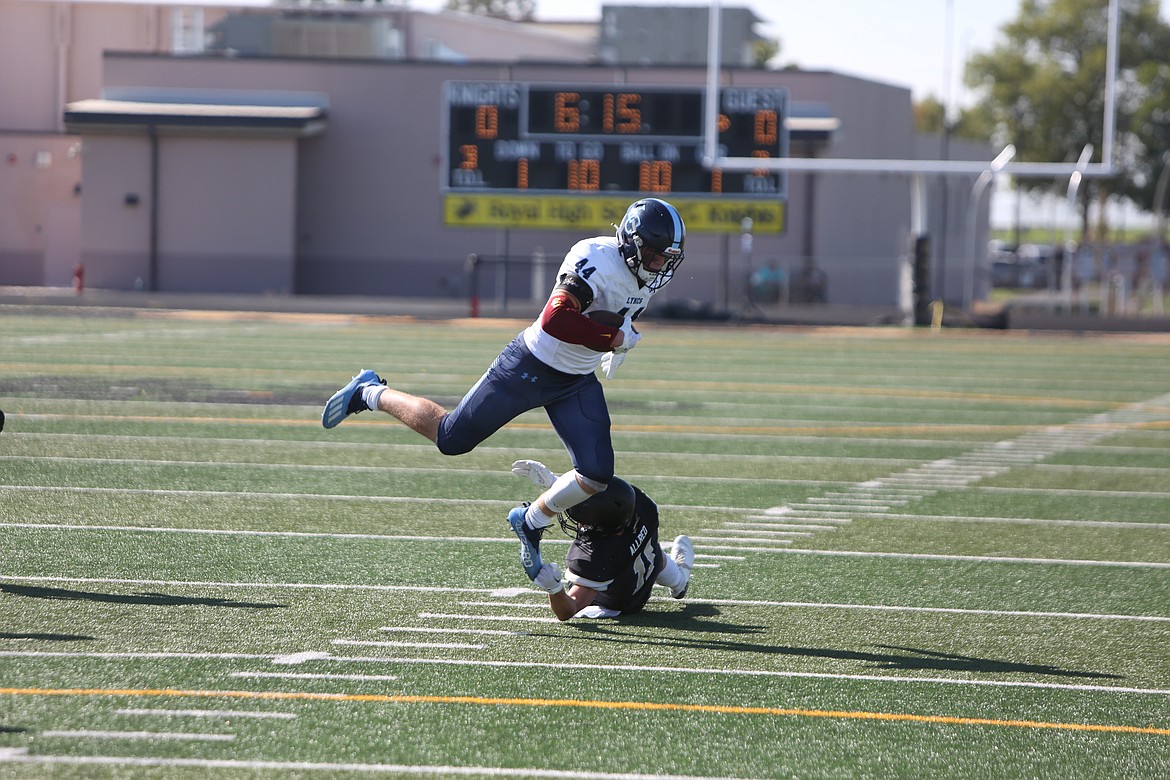 Defensive back Lance Allred reaches to tackle Lynden-Christian running back Kade Eldridge during the first half on Saturday.