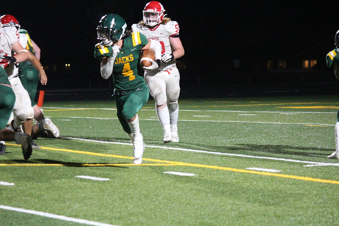 Quincy’s Jackson Yeates (4) heads around end on a touchdown run in the Jacks’ 34-6 win over Brewster Friday.