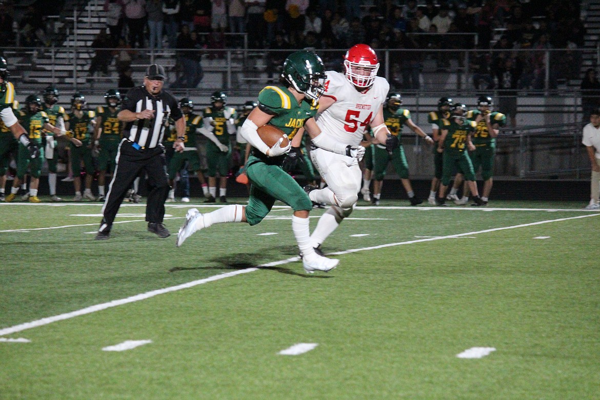 Jackson Yeats (4), Quincy, runs through the Brewster defense on his way to the end zone in Quincy’s 34-6 win Friday.