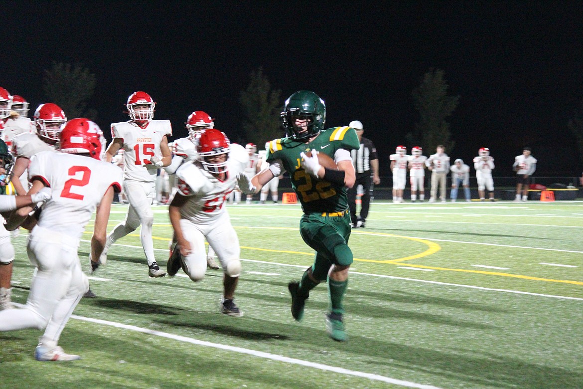 Quincy running back Jayden Richards (22) takes the ball upfield during Quincy’s 34-6 win over Brewster Friday.