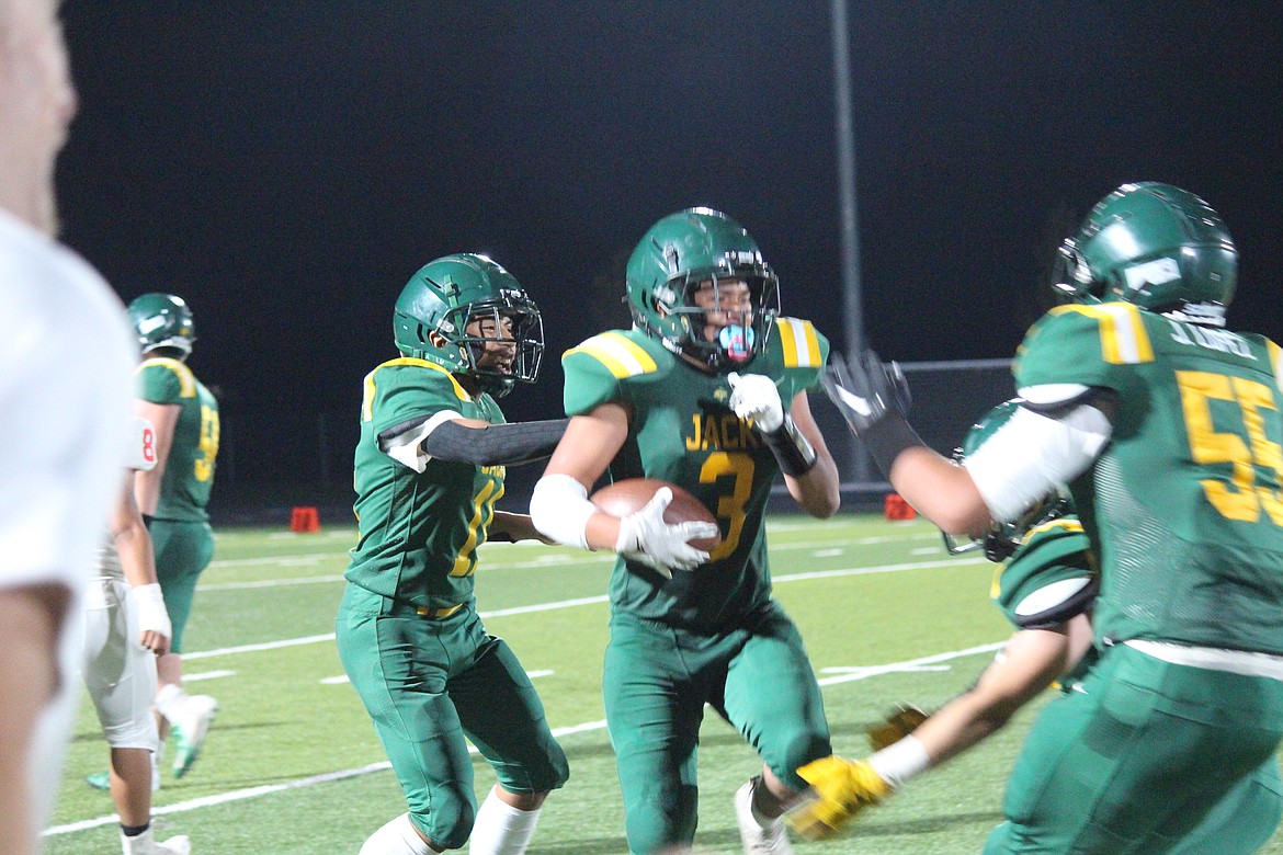 David Gudino (3), Quincy, celebrates a touchdown with his teammates during Quincy’s 34-6 win.