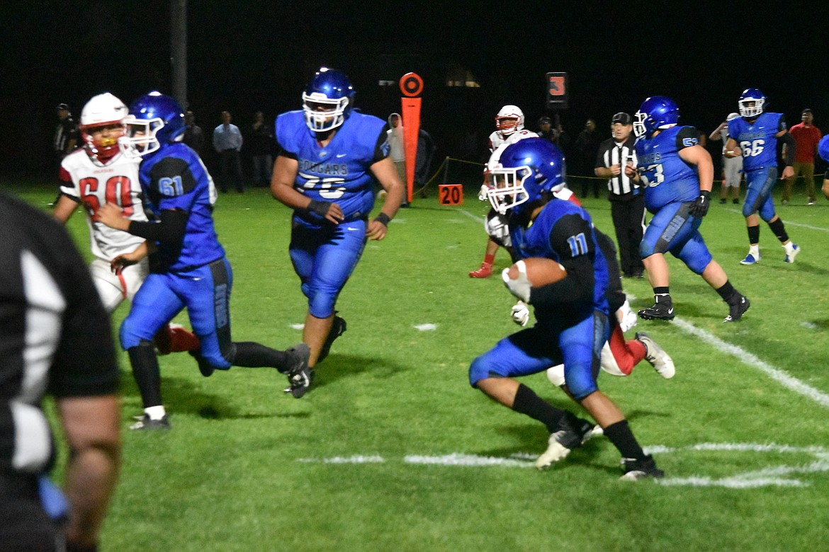 Warden senior Israel Hernandez (11) rushes the ball during the league game against Granger Friday night. He also had 5 receives for 70 yards.